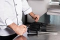 Chef hands with knives at professional restaurant. Closeup hands with knife.