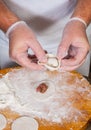 Chef hands in process of making home-made dumplings, ravioli