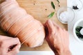 Chef hands with raw meat pork roast cooking preparation