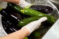 Chef hands rinsing vegetables under tap water, close up.