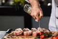 Chef hands spray meat at kitchen restaurant. Closeup chef hands pour beef.