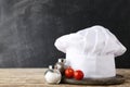 Chef hat with salt, pepper and tomato Royalty Free Stock Photo