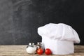 Chef hat with salt, pepper and tomatoes Royalty Free Stock Photo