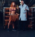 A chef and his female helper in a sausage storage.