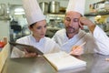 Chef and helper at bistro kitchen Royalty Free Stock Photo