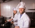 Chef and his helper at bistro kitchen Royalty Free Stock Photo