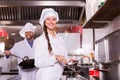 Chef and his helper at bistro kitchen Royalty Free Stock Photo