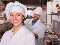 Chef and his helper at bistro kitchen Royalty Free Stock Photo