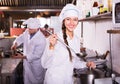 Chef and his helper at bistro kitchen Royalty Free Stock Photo