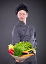 Chef holding a basket of delicious fresh vegetables