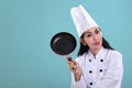 Chef holding a cooking pan, blue background