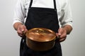 Chef holding copper pan