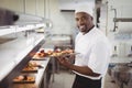 Chef holding dessert tray in commercial kitchen