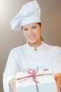 Chef holding forwards gift wrapped box