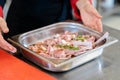 Chef holding a metal container with lamb steak Royalty Free Stock Photo