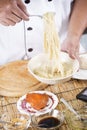 Chef holding the noodle from the bowl with fork Royalty Free Stock Photo