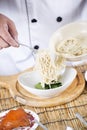 Chef holding the noodle from the bowl with fork Royalty Free Stock Photo