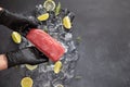 Chef holding piece of Fresh cooled tuna Fish fillet over pieces of ice