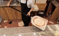 Chef Holding Pizza Peel with Uncooked Cheese Pizza Royalty Free Stock Photo