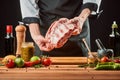 Chef holding raw beef ribs. Cooking perfect barbeque ribs