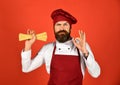 Chef holding spaghetti in his hand and showing ok sign Royalty Free Stock Photo