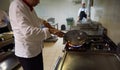 Chef in hotel kitchen prepare food with fire Royalty Free Stock Photo