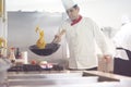 Chef in hotel kitchen prepare food with fire Royalty Free Stock Photo