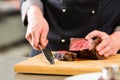 Chef in hotel or restaurant kitchen cooking Royalty Free Stock Photo