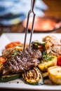 Chef in hotel or restaurant kitchen cooking only hands. Prepared beef steak with vegetable decoration Royalty Free Stock Photo