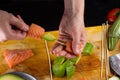 Chef is implating salmon filtet on a skewer Royalty Free Stock Photo