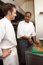 Chef Instructing Trainee Royalty Free Stock Photo