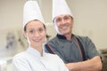 Chef instructing trainee in restaurant kitchen Royalty Free Stock Photo