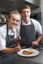 Chef Instructing Trainee In Restaurant Kitchen Royalty Free Stock Photo