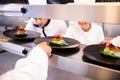 Chef keeping appetizer plate ready on the order station