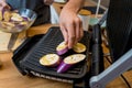 Chef at the kitchen preparing grilled eggplants with garlic Royalty Free Stock Photo