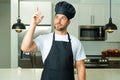 Chef on kitchen. Professional chef man in uniform on kitchen. Bearded chef, cook or baker. Male chef over kitchen