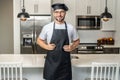 Chef on kitchen. Professional chef man in uniform on kitchen. Bearded chef, cook or baker. Male chef over kitchen