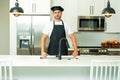 Chef on kitchen. Professional chef man in uniform on kitchen. Bearded chef, cook or baker. Male chef over kitchen