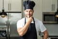 Chef on kitchen. Professional chef man in uniform on kitchen. Bearded chef, cook or baker. Male chef over kitchen