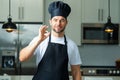 Chef on kitchen. Professional chef man in uniform on kitchen.Chef cook with ok sign, delicious food. Handsome man in