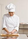 Chef in kneading dough in commercial kitchen Royalty Free Stock Photo