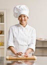 Chef kneading dough in commercial kitchen