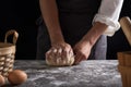 A chef is kneading dough using eggs, kitchen dark background, professional photography light Royalty Free Stock Photo