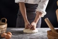 A chef is kneading dough using eggs, kitchen dark background, professional photography light Royalty Free Stock Photo