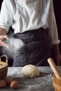 A chef is kneading dough using eggs, kitchen dark background, professional photography light Royalty Free Stock Photo