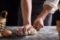 A chef is kneading dough using eggs, kitchen dark background, professional photography light Royalty Free Stock Photo