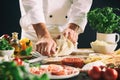 Chef kneading pastry dough for pasta or pizza