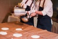 Chef ladle pours big pancakes on the table