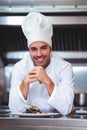 Chef leaning on the counter with a dish Royalty Free Stock Photo