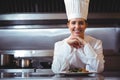 Chef leaning on the counter with a dish Royalty Free Stock Photo